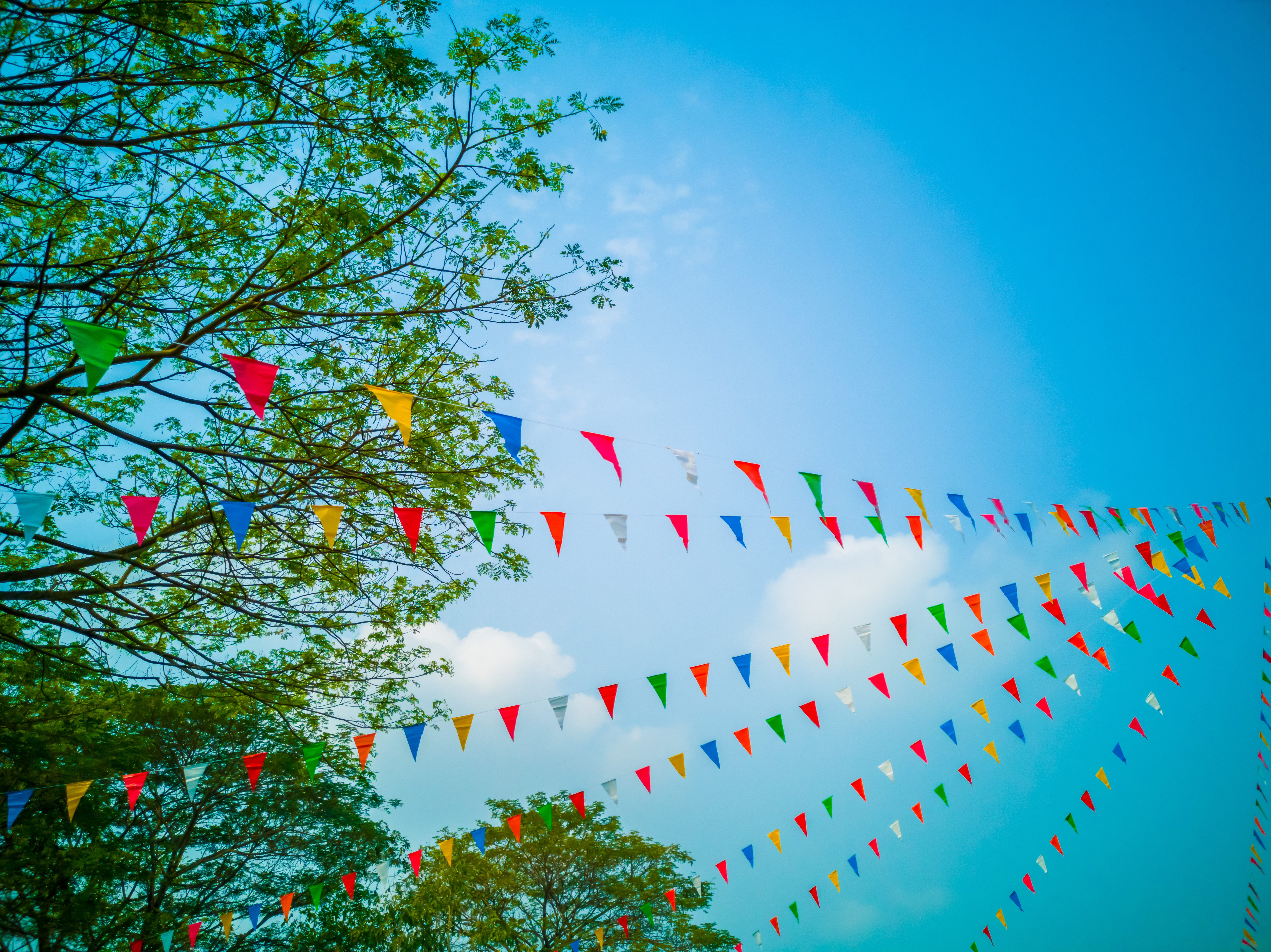 blue sky with multi colored flag banner